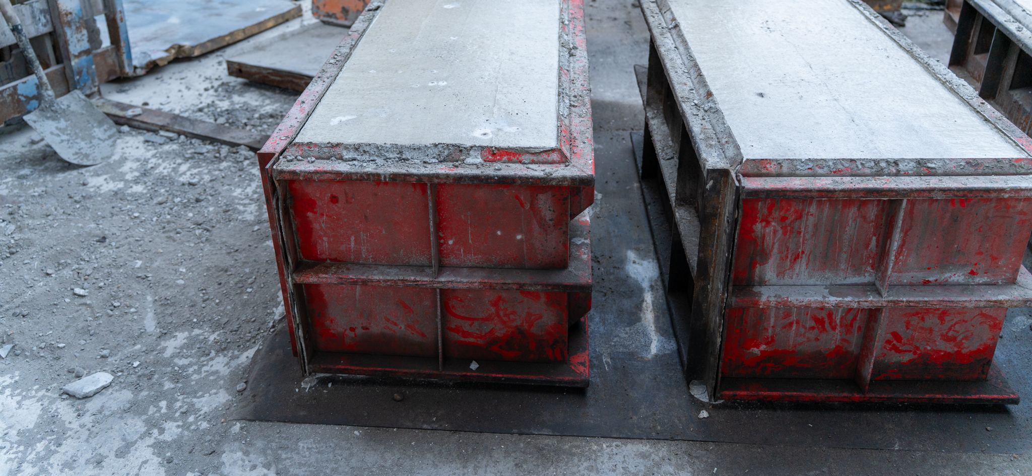 Steel moulds freshly filled with concrete to cast interlocking blocks